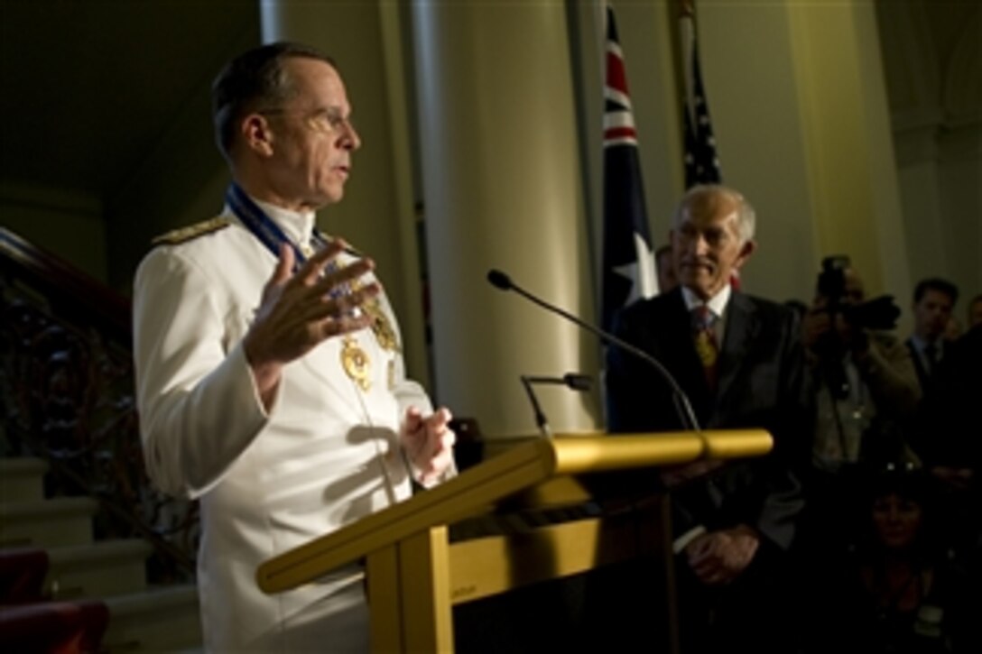 Chairman of the Joint Chiefs of Staff Adm. Mike Mullen thanks audience members after being presented the Officer of the Order of Australia in Melbourne, Australia, on Nov. 7, 2010.  Mullen is visiting Australia participating in the annual U.S.-Australia defense ministerials with Secretary of Defense Robert M. Gates and Secretary of State Hillary Rodham Clinton.  