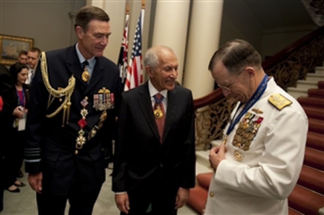 Chief of the Australian Defense Force Air Chief Marshal Angus Houston and Governor of Victoria David de Kretser admire the Officer of the Order of Australia presented to Chairman of the Joint Chiefs of Staff Adm. Mike Mullen in Melbourne, Australia, on Nov. 7, 2010.  Mullen is visiting Australia participating in the annual U.S.-Australia defense ministerials with Secretary of Defense Robert M. Gates and Secretary of State Hillary Rodham Clinton.  
