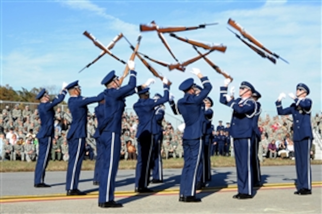 Members of the U.S. Air Force Honor Guard drill team perform a maneuver during the 11th Wing commander's call on Joint Base Andrews, Md., Nov. 2, 2010. The commander's call highlighted the unique assets of the 11th WG through demonstrations by the 1st Helicopter Squadron, the Air Force Honor Guard and the Air Force Band.
