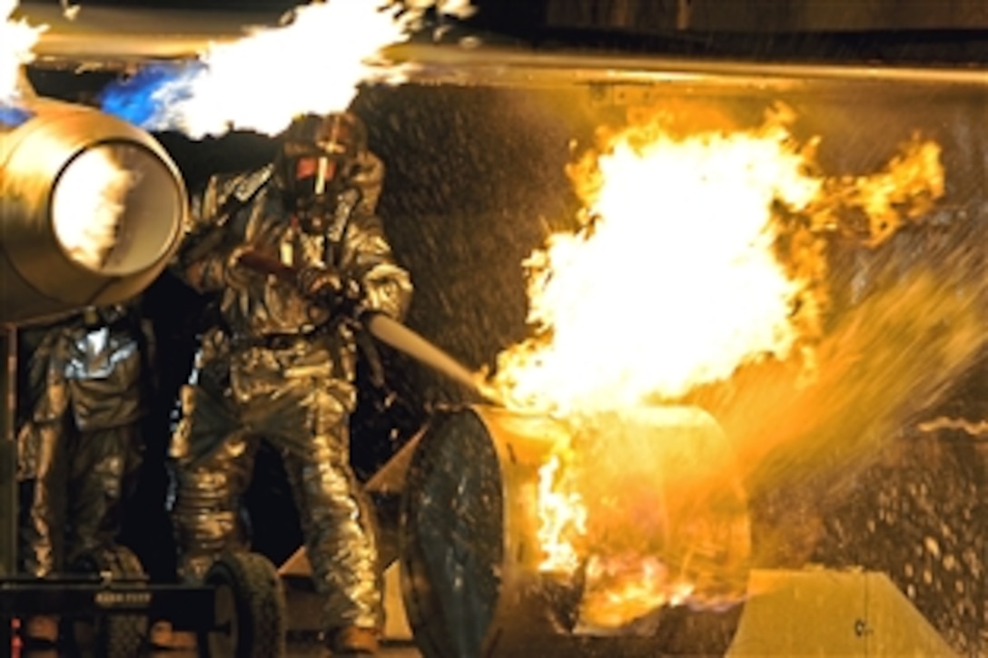 Firefighters practice extinguishing an aircraft fire at a U.S. military installation in Southeast Asia, Oct. 27, 2010. The firefighters are assigned to the 386th Expeditionary Civil Engineer Squadron.