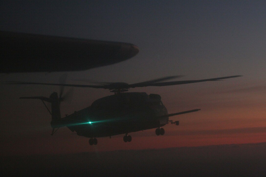 A CH-53E "Super Stallion" helicopter with Marine Medium Helicopter Squadron 163 (Rein) prepares to receive fuel from a KC-130J "Hercules" aircraft with Marine Aerial Refuel Transport Squadron 352 during a refuel training exercise off the coast of San Diego Nov. 8.