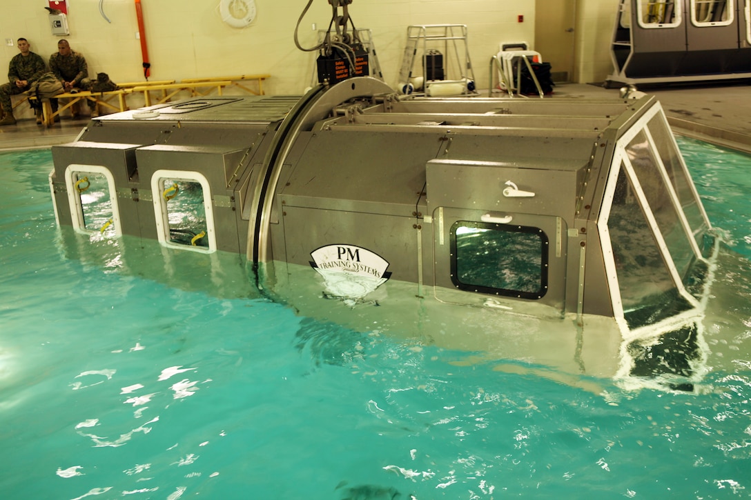 The Modular Amphibious Egress Trainer located at the Water Survivor Training Facility aboard Camp Lejeune, N.C., teaches Marines and sailors how to escape from a submerging helicopter. Marines with Combat Logistics Regiment 2, 2nd Marine Logistics Group, learned what to do in this situation Nov. 9, 2010. As the helo is submerged under water, a group of six Marines or sailors inside make their way out of the helicopter through one of the unlocked hatches located throughout the simulated aircraft.  (U.S. Marine Corps photo by Pfc. Franklin E. Mercado)