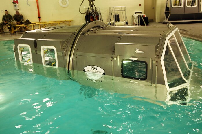 The Modular Amphibious Egress Trainer located at the Water Survivor Training Facility aboard Camp Lejeune, N.C., teaches Marines and sailors how to escape from a submerging helicopter. Marines with Combat Logistics Regiment 2, 2nd Marine Logistics Group, learned what to do in this situation Nov. 9, 2010. As the helo is submerged under water, a group of six Marines or sailors inside make their way out of the helicopter through one of the unlocked hatches located throughout the simulated aircraft.  (U.S. Marine Corps photo by Pfc. Franklin E. Mercado)