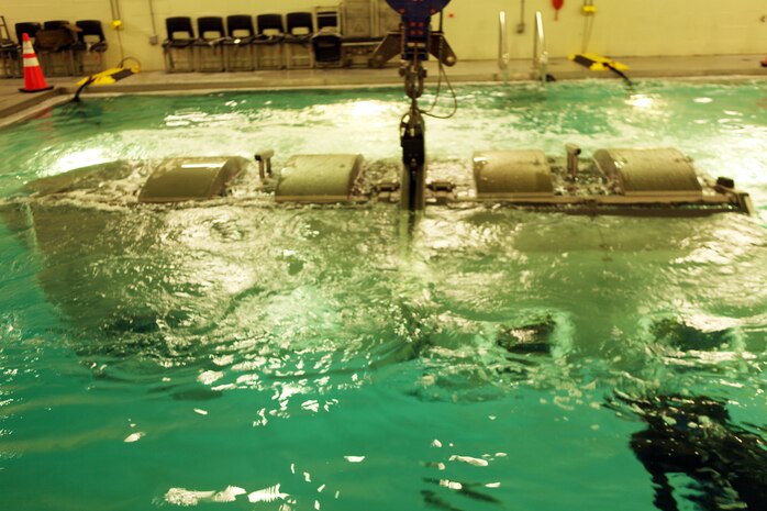 The Modular Amphibious Egress Trainer located at the Water Survivor Training Facility aboard Camp Lejeune, N.C., teaches Marines and sailors how to escape from a submerging helicopter. Marines with Combat Logistics Regiment 2, 2nd Marine Logistics Group, learned what to do in this situation Nov. 9, 2010. As the helo is submerged under water, a group of six Marines or sailors inside make their way out of the helicopter through one of the unlocked hatches located throughout the simulated aircraft.  (U.S. Marine Corps photo by Pfc. Franklin E. Mercado)