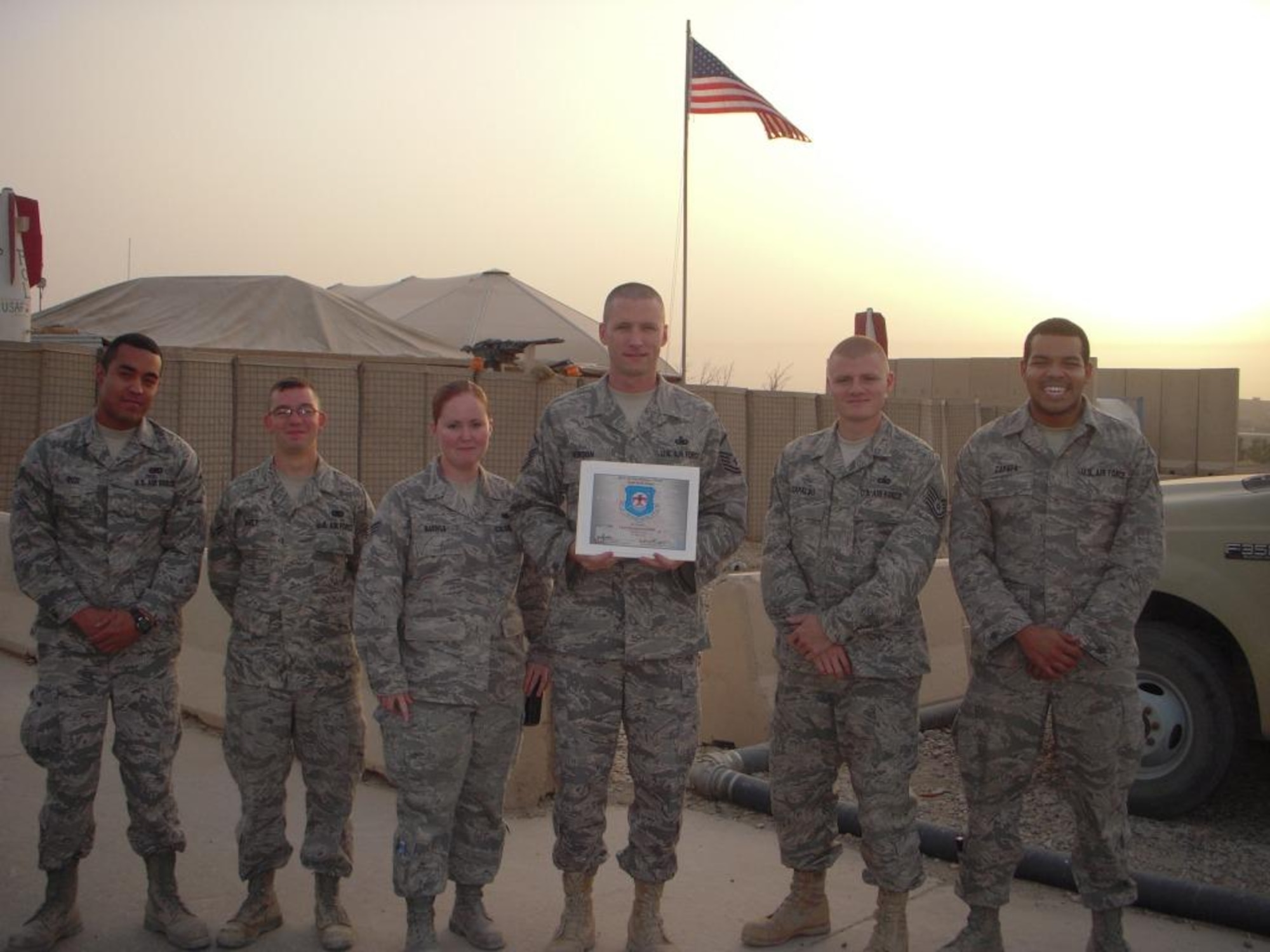 Deployed members of the 36th Logistical Readiness Squadron, currently stationed in Iraq, pose after winning Team of the Month at Army Contingency Operating Base Adder in September. The Expeditionary LRS members beat out civil engineer, contracting and security forces units to earn top honors. The Airmen exceeded Air Force standards for output by 37 percent providing fuels support to 223 area of responsibility aircraft and issuing more than 50,000 gallons of fuel at an average response time of just 19 minutes. (U. S. Air Force Courtesy Photo)
