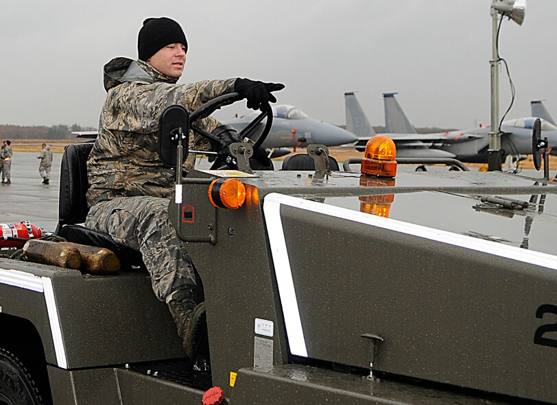 Staff Sgt. Chris Sperry, a crew chief with the 44th Fighter Squadron, points to where he plans to take the F-15 he’s toeing on the flightline at Chitose Air Base, Japan, Nov. 9.  Nearly 200 Airmen from Kadena are deployed for a 2-week Aviation Training Location. The ATR allows for bilateral training with the Japan Air Self Defense Forces for the common defense of Japan while reducing aircraft noise in Okinawa. (U.S. Air Force photo/Tech. Sgt. Mike Tateishi)