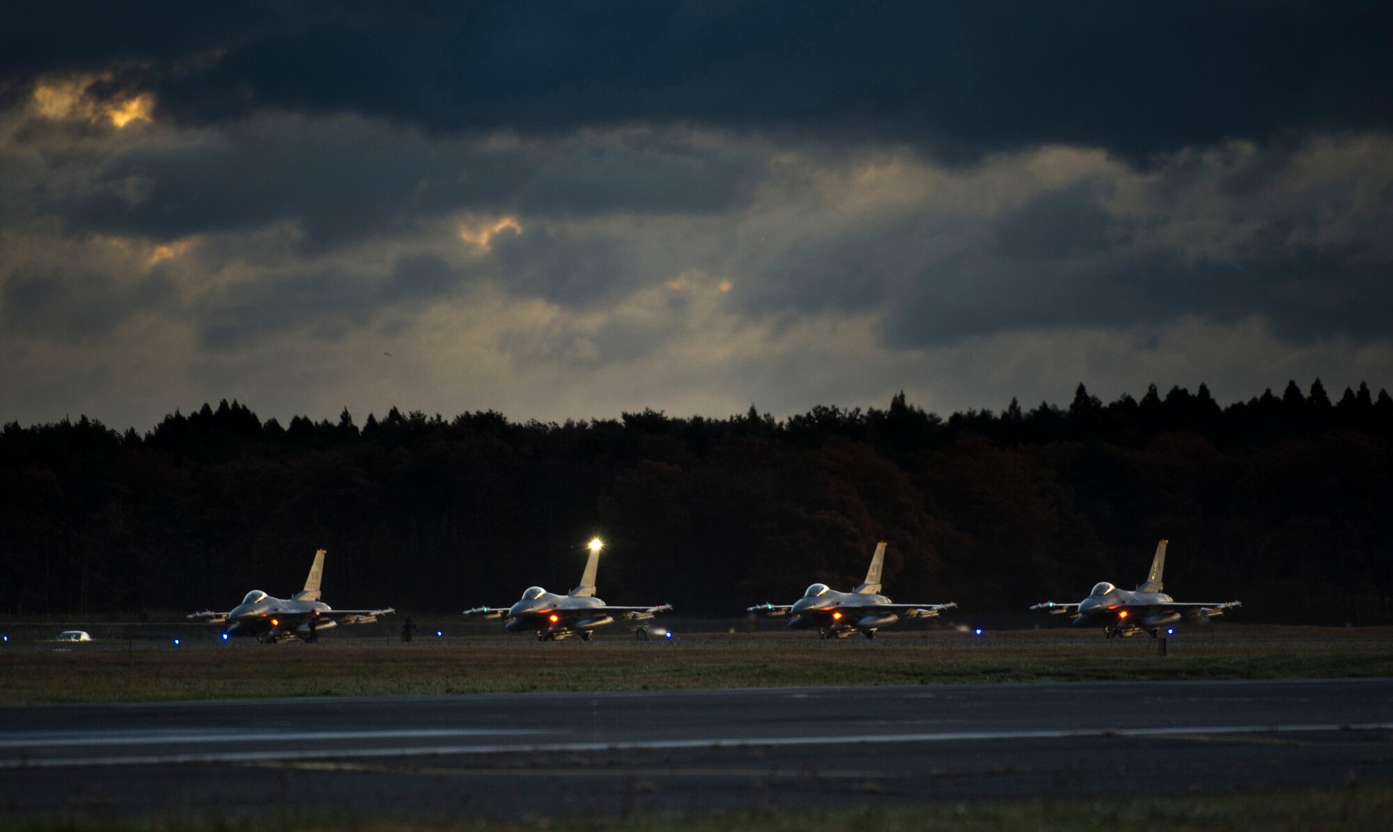Four F-16 Fighting Falcons line up in preparation for takeoff on the final day of an operational readiness exercise at Misawa Air Base, Japan, Nov. 10, 2010. The pilots ran through scenarios including avoidance of simulated law of armed conflict violations and in-flight emergencies. (U.S. Air Force photo by Staff Sgt. Samuel Morse/Released)