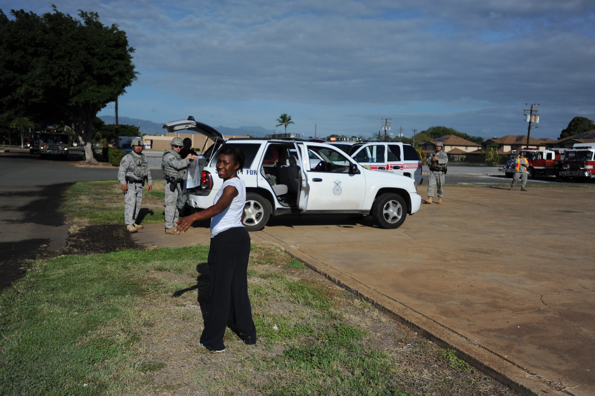 Staff Sgt. Terrell Mickens alerts 647th Air Base Group security forces members of a simulated explosion behind the softball fields near Kuntz Gate at Joint Base Pearl Harbor Hickam, Hawaii Nov. 9. A Major Accident Response Exercise in which a simulated terrorist drove an explosive truck into a group of Airmen was conducted to test the base's ability to respond in case of a major accident. (U.S. Air Force photo by Staff Sgt. Nathan Allen)