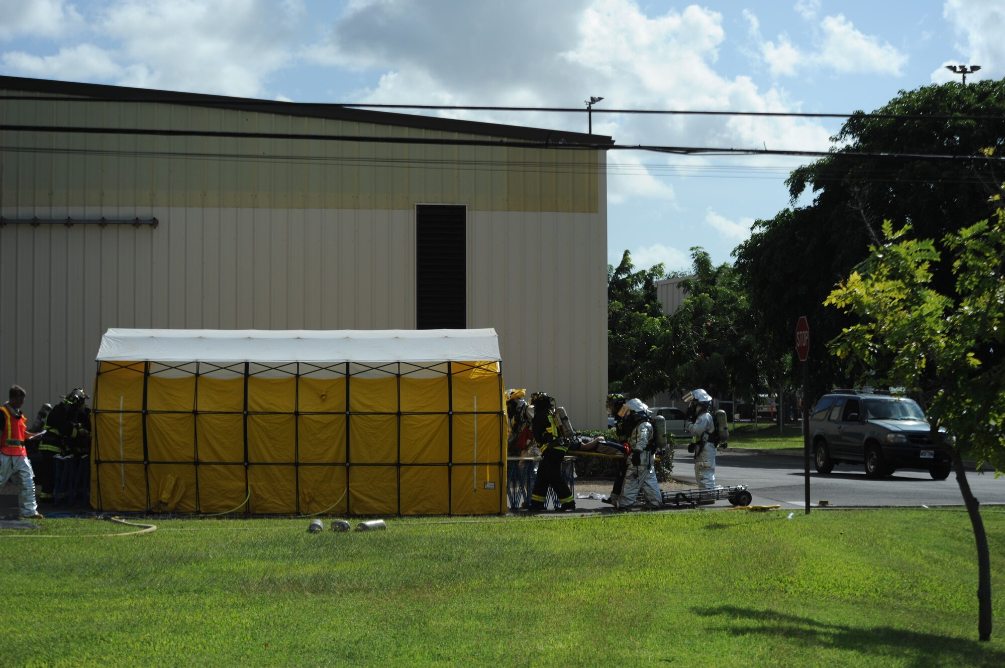 Paramedics prepare a patient to be sanitized after he was contaminated by a simulated explosion during a Major Accident Response Exercise behind the softball fields near Kuntz Gate at Joint Base Pearl Harbor Hickam, Hawaii Nov. 9. A Major Accident Response Exercise in which a simulated terrorist drove an explosive truck into a group of Airmen was conducted to test the base's ability to respond in case of a major accident. (U.S. Air Force photo by Staff Sgt. Nathan Allen)
