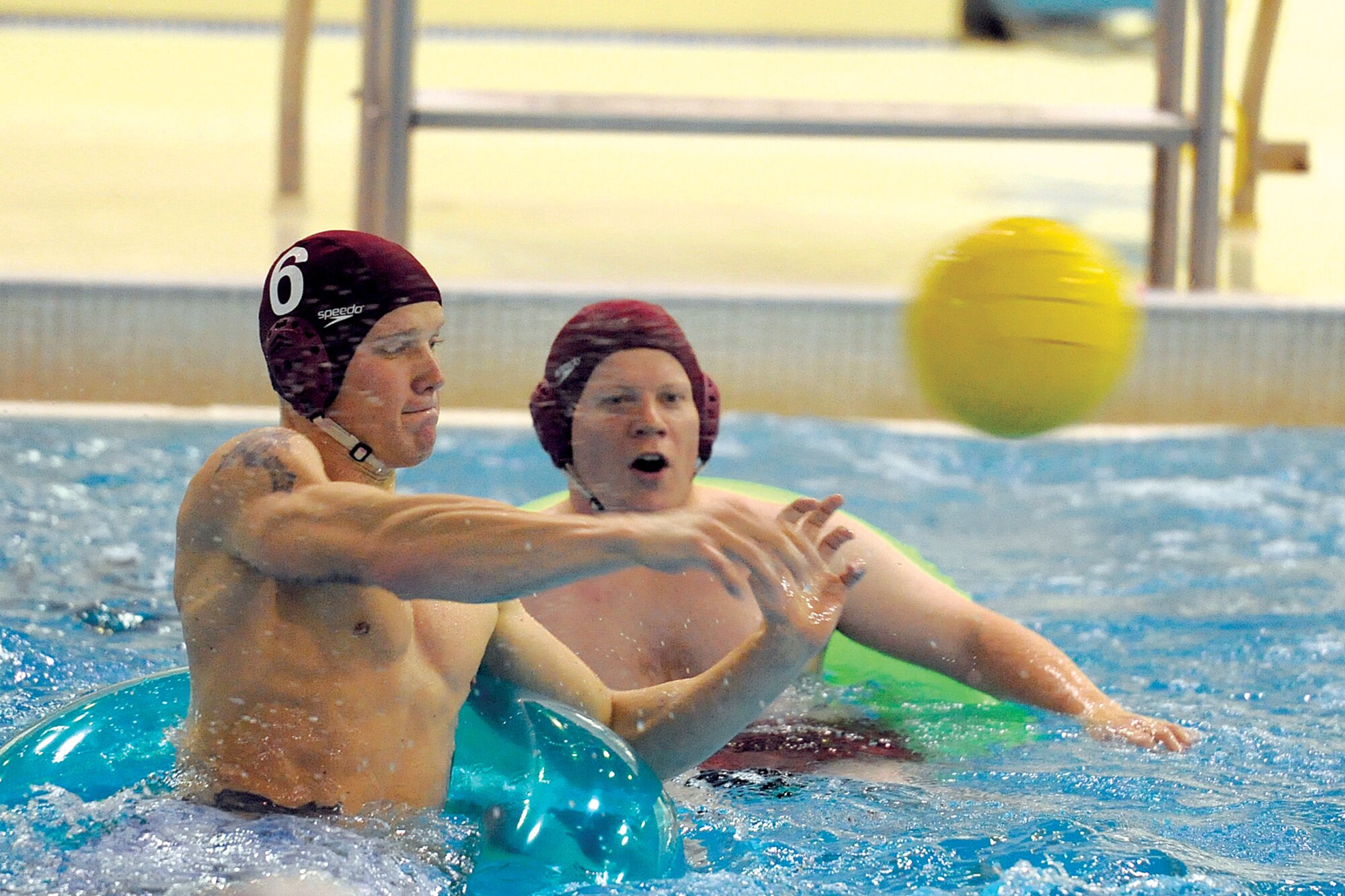 Walter Hicks watches as his U.S. Army Alaska teammate Thomas Watega fires a shot at the Alaska National Guard goal in the first half of an inner tube water polo match Nov. 3 at Joint Base Elmendorf-Richardson’s Buckner Physical Fitness Center Pool.
  (U.S. Air Force photo/John Pennell) 