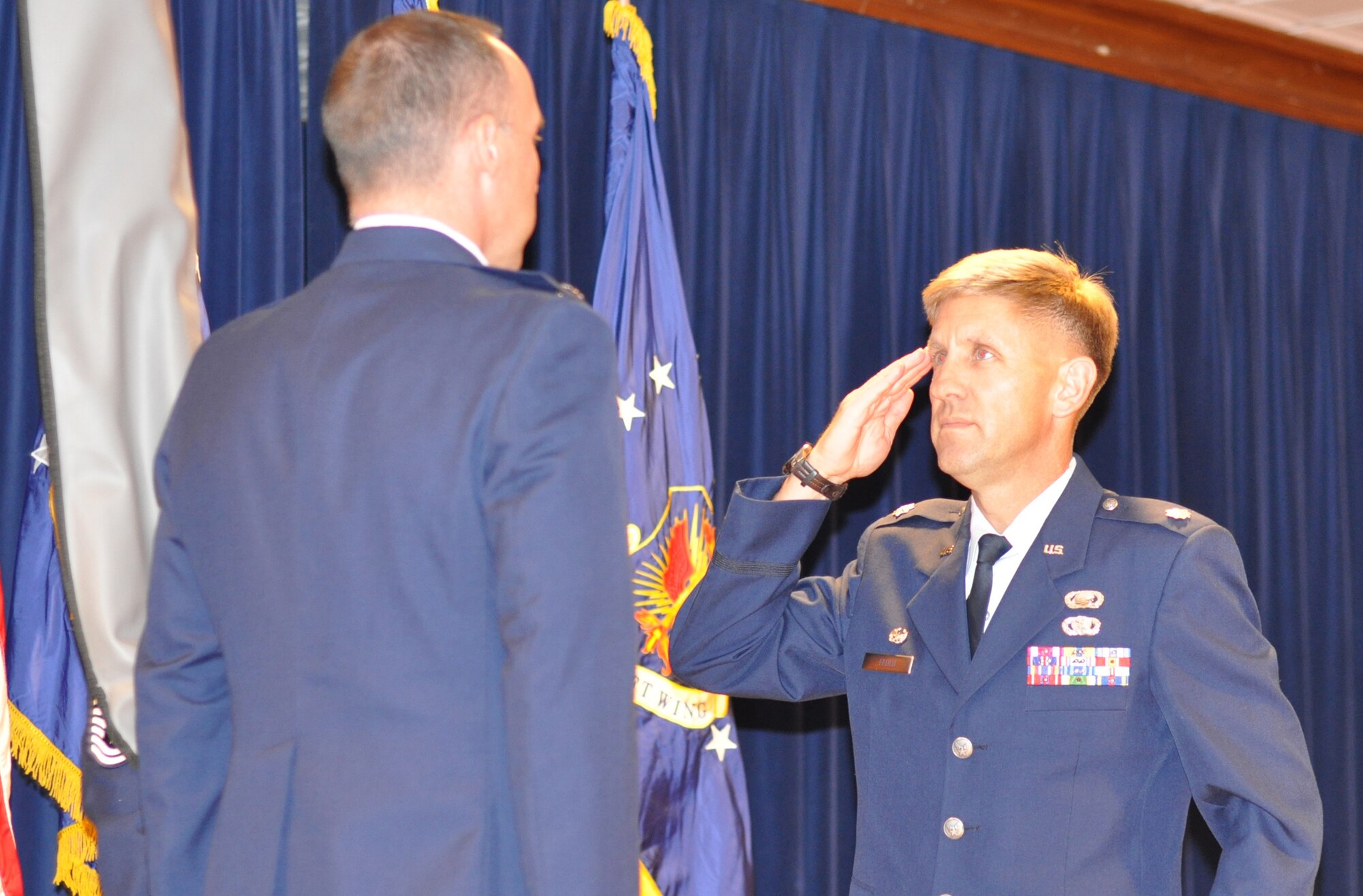 Air Force Reserve Lt. Col. Alan Flolo salutes Lt. Col. Michael Burns, 302nd Mission Support Group commander, during a ceremony Nov. 6 recognizing the activation of the 302nd Force Support Squadron at Peterson Air Force Base, Colo. Both the 302nd Services and Mission Support Flights were inactivated officially Oct. 15, giving way to the activation of the 302nd FSS. The new squadron consolidates 15 sub organizations into four and creates new flights that include force development, manpower and personnel, Airman and family services and sustainment services. Colonel Flolo commands the newly-activated 302nd FSS. (U.S. Air Force photo/Staff Sgt. Stephen J. Collier)
