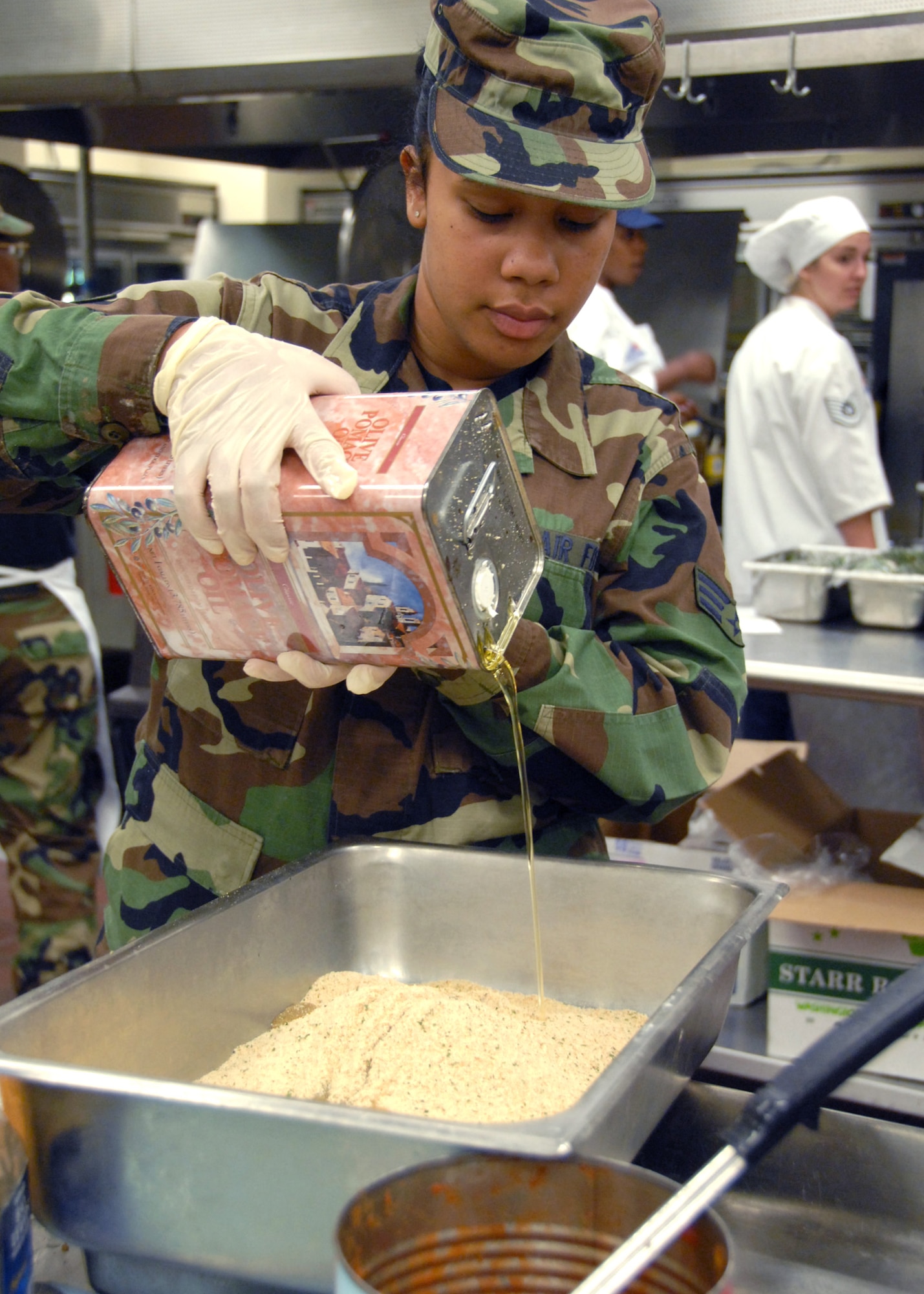 Senior Airman Brittnie Lewis pours oil into a breading mix recently at the Duke Field, Fla. dining facility. The 919th SVF inactivated Oct. 15, 2010, and reservists in the flight joined the newly created 919th Force Support Squadron. Airman Lewis is with the 919th Services Flight. (U.S. Air Force photo/Staff Sgt. Samuel King Jr.)