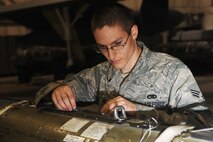 MINOT AIR FORCE BASE, N.D. -- Senior Airman Scott Hill, 5th Aircraft Maintenance Squadron weapons loader, inspects a CBU – 103 Cluster Bomb that will be loaded to a B-52H Stratofortress for a load competition here Oct 29. Load competitions are used to build unit morale and cohesiveness, as well as a chance for weapons loaders to show off their skills to their peers and leadership. (U.S. Air Force photo/Airman 1st Class Aaron-Forrest Wainwright)