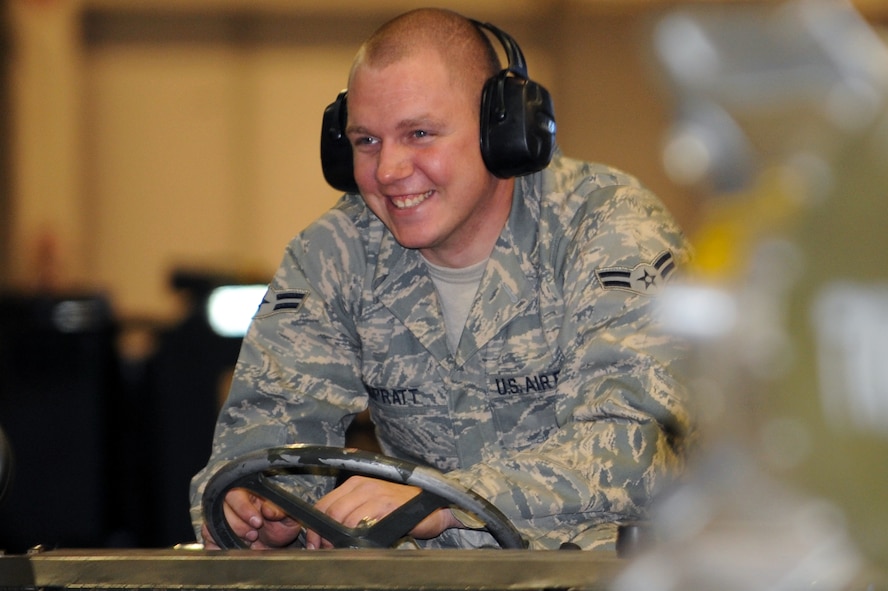 MINOT AIR FORCE BASE, N.D. -- Airman 1st Class Damian Spratt, 5th Aircraft Maintenance Squadron weapons loader, waits for his team members to load a CBU – 103 Cluster Bomb to the MHU – 83 bomb loader vehicle here Oct 29. Load competitions are used to build unit morale and cohesiveness, as well as a chance for weapons loaders to show off their skills to their peers and leadership. (U.S. Air Force photo/Airman 1st Class Aaron-Forrest Wainwright)