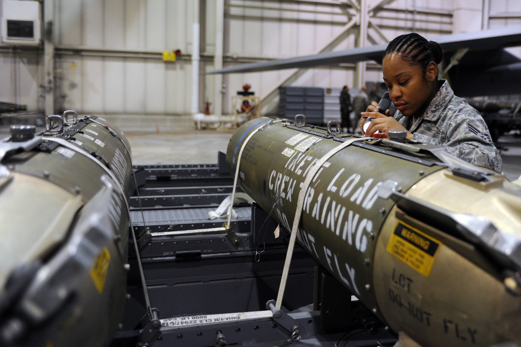MINOT AIR FORCE BASE, N.D. -- Senior Airman Shantel Lett, 5th Aircraft Maintenance Squadron weapons loader, inspects a CBU – 103 Cluster Bomb that will be loaded to a B-52H Stratofortress for a load competition here Oct. 29. Load competitions are used to build unit morale and cohesiveness, as well as a chance for weapons loaders to show off their skills to their peers and leadership. (U.S. Air Force photo/Airman 1st Class Aaron-Forrest Wainwright)