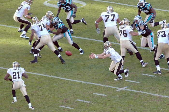 New Orleans Saints quarterback Drew Brees laterals the ball to running back Julius Jones during the Carolina Panthers and New Orleans Saints football game Nov. 7, 2010, in Charlotte, N.C. The Carolina Panthers hosted color guard members from all branches of the military in recognition of Veterans Day. The Panthers lost to the Saints 34-3. (U.S. Air Force photo/Staff Sgt. Marie Brown)