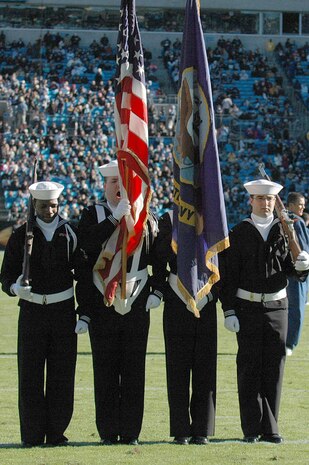 Members of the U.S. Navy Color Guard receive recognition during the Carolina Panthers and New Orleans Saints half-time show during the playing of "Anchors Away" Nov. 7, 2010, in Charlotte, N.C. The Carolina Panthers hosted color guard members from all branches of the military in recognition of Veterans Day. The Navy color guard is from Joint Base Charleston, S.C.  (U.S. Air Force photo/Staff Sgt. Marie Brown)