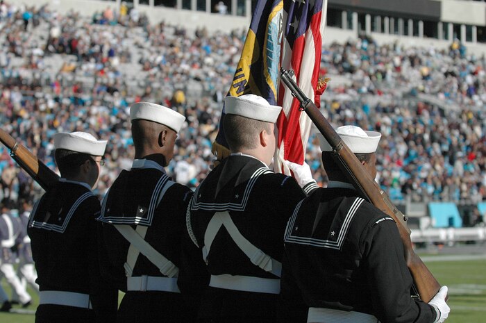 Members of the Navy color guard stands ready to post the colors during the Carolina Panthers and New Orleans Saints pre-game ceremony Nov. 7, 2010, in Charlotte, N.C. The Carolina Panthers hosted color guard members from all branches of the military in recognition of Veterans Day. The Navy color guard team is from Joint Base Charleston, S.C. (U.S. Air Force photo/Staff Sgt. Marie Brown)