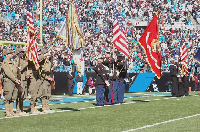 Members of the U.S. Army (left), Marine Corp(center), and Navy (right) post the colors during the Carolina Panthers and New Orleans Saints pre-game ceremony Nov. 7, 2010, in Charlotte, N.C. The Carolina Panthers hosted color guard members from all branches of the military in recognition of Veterans Day. The Army color guard is from Fort Jackson, S.C., the Marine Corps color guard is from Marine Corps Air Station New River, Jacksonville, Fla., and the Navy color guard is from Joint Base Charleston, S.C. (U.S. Air Force photo/Staff Sgt. Marie Brown)