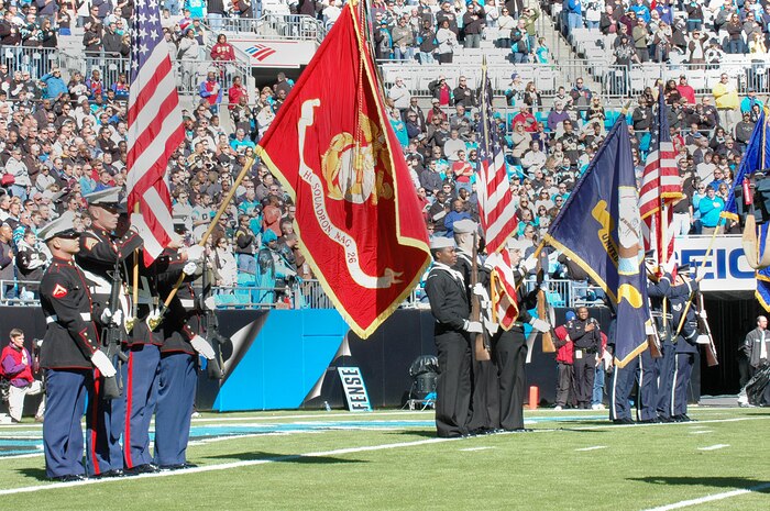 Members of the Marine Corps (left), Navy (center), and Air Force (right) post the colors during the Carolina Panthers and New Orleans Saints pre-game ceremony Nov. 7, 2010, in Charlotte, N.C. The Carolina Panthers hosted color guard members from all branches of the military in recognition of Veterans Day. The Marine Corps color guard is from Marine Corps Air Station New River, Jacksonville, Fla. The Navy color guard is from Joint Base Charleston, S.C., and the Air Force color guard is from Asheville, N.C. (U.S. Air Force photo/Staff Sgt. Marie Brown)