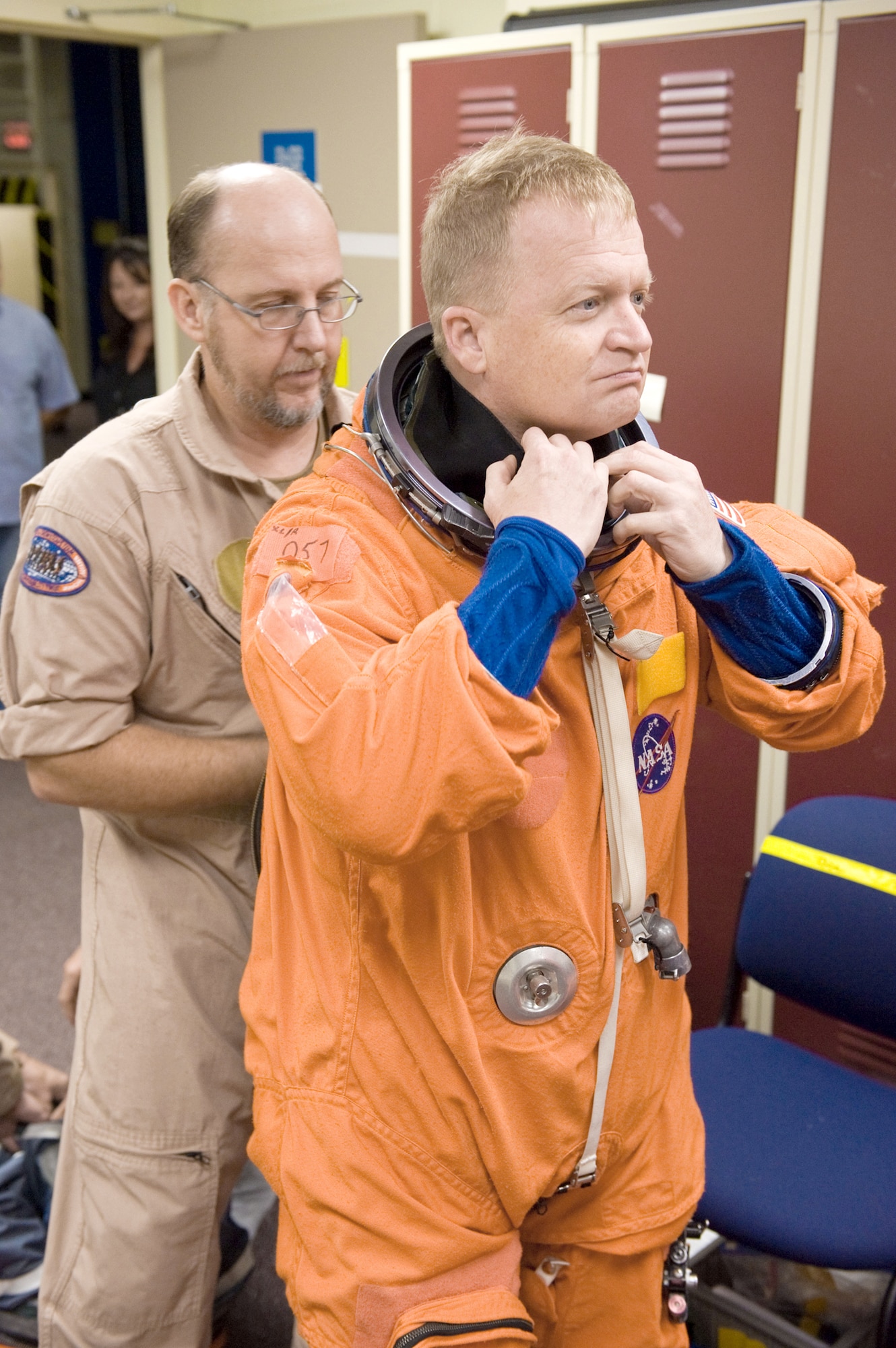 NASA astronaut Col. Eric Boe dons a training version of his shuttle launch and entry suit Sept. 24, 2010 in preparation for a training session in the Space Vehicle Mock-up Facility at NASA's Johnson Space Center in Houston. United Space Alliance suit technician Steve Sholtz assisted Colonel Boe during the session. Colonel Boe is a STS-133 pilot. (Courtesy photo/James Blair, NASA) 