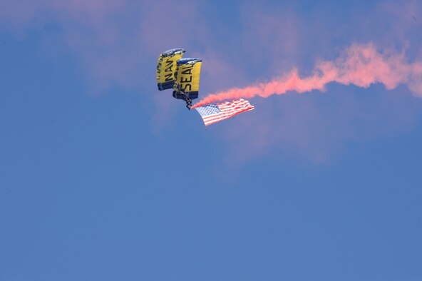 FT. PIERCE, Fla. - Two members of the Leap Frogs, the Navy's official parachute team, do a demonstration jump from a 920th RQW King aircraft, with an American flag during the 25th Annual National Navy UDT-SEAL Museum Muster in Fort Pierce, Fla., Nov. 6. The jump was one of many demonstrations performed that day for a crowd of approximately 5,000 service members and civilians. The King is an HC-130P/N combat search and rescue version of the C-130 from the 920th Rescue Wing, at nearby Patrick Air Force Base (Photo/Senior Airman Anna-Marie Wyant). 