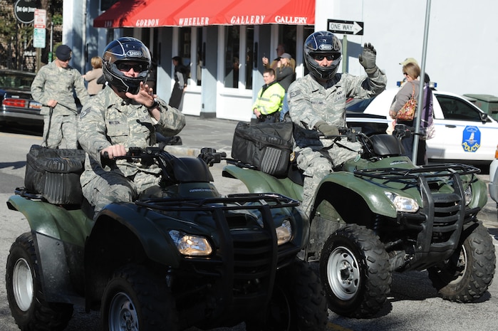 Staff Sgts. Anthony Waldon and Michael Whitecomb wave to the crowd during the Veterans Day parade Nov. 7, 2010, in downtown Charleston, S.C. Sergeants Waldon and Whitecomb are members of the 628th Security Forces Squadron. (U.S. Air Force photo/James M. Bowman)(released)