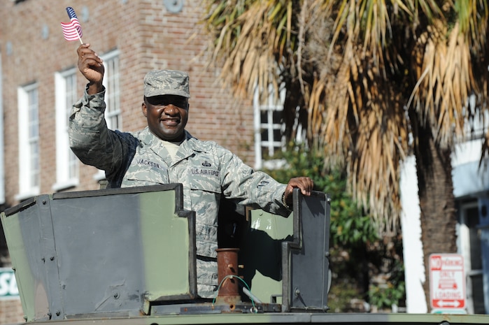 Chief Master Sgt. Thomas Jackson rides in a Humvee and waves to the crowd during the Veterans Day parade Nov. 7, 2010, in downtown Charleston, S.C. Chief Jackson is the command chief for the 628th Air Base Wing. (U.S. Air Force photo/James M. Bowman)(released)