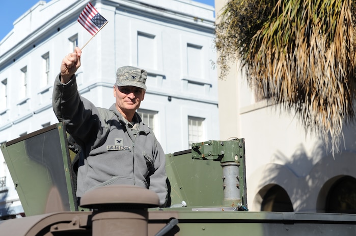 Col. Steven Chapman rides in a Humvee and waves to the crowd during the Veterans Day parade Nov. 7, 2010, in downtown Charleston, S.C. Colonel Chapman is the 315th Airlift Wing commander. (U.S. Air Force photo/James M. Bowman)(released)