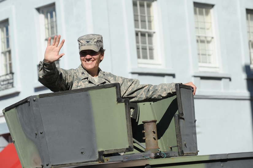 Col. Martha Meeker rides in the gunner seat of a Humvee and waves to the crowd during the Veterans Day parade Nov. 7, 2010, in downtown Charleston, S.C. Colonel Meeker is the Joint Base Charleston Commander. (U.S. Air Force photo/James M. Bowman)(released)