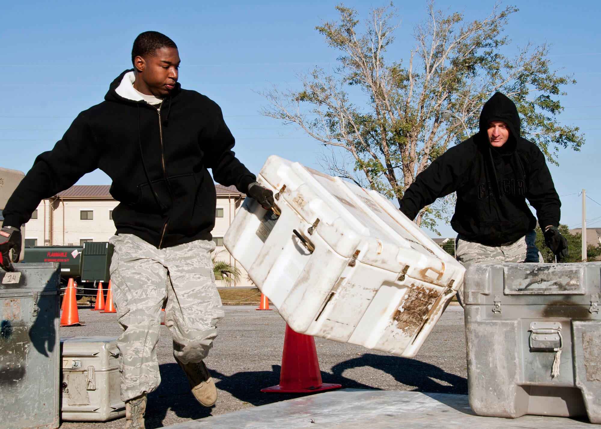 Staff Sgt. Dwayne Hopkins and Tech. Sgt. Glennis Hamilton, part of Hurlburt Field’s 1st Special Operations Logistics Readiness Squadron’s “men in black.” build a pallet at the first-ever Eglin/Hurlburt Field LRS competition Nov. 5.  Hurlburt’s “Team A” won the overall competition almost five minutes.  The “best-time” competition included pallet building, obstacle courses and tire changing.  (U.S. Air Force photo/ Samuel King Jr.)