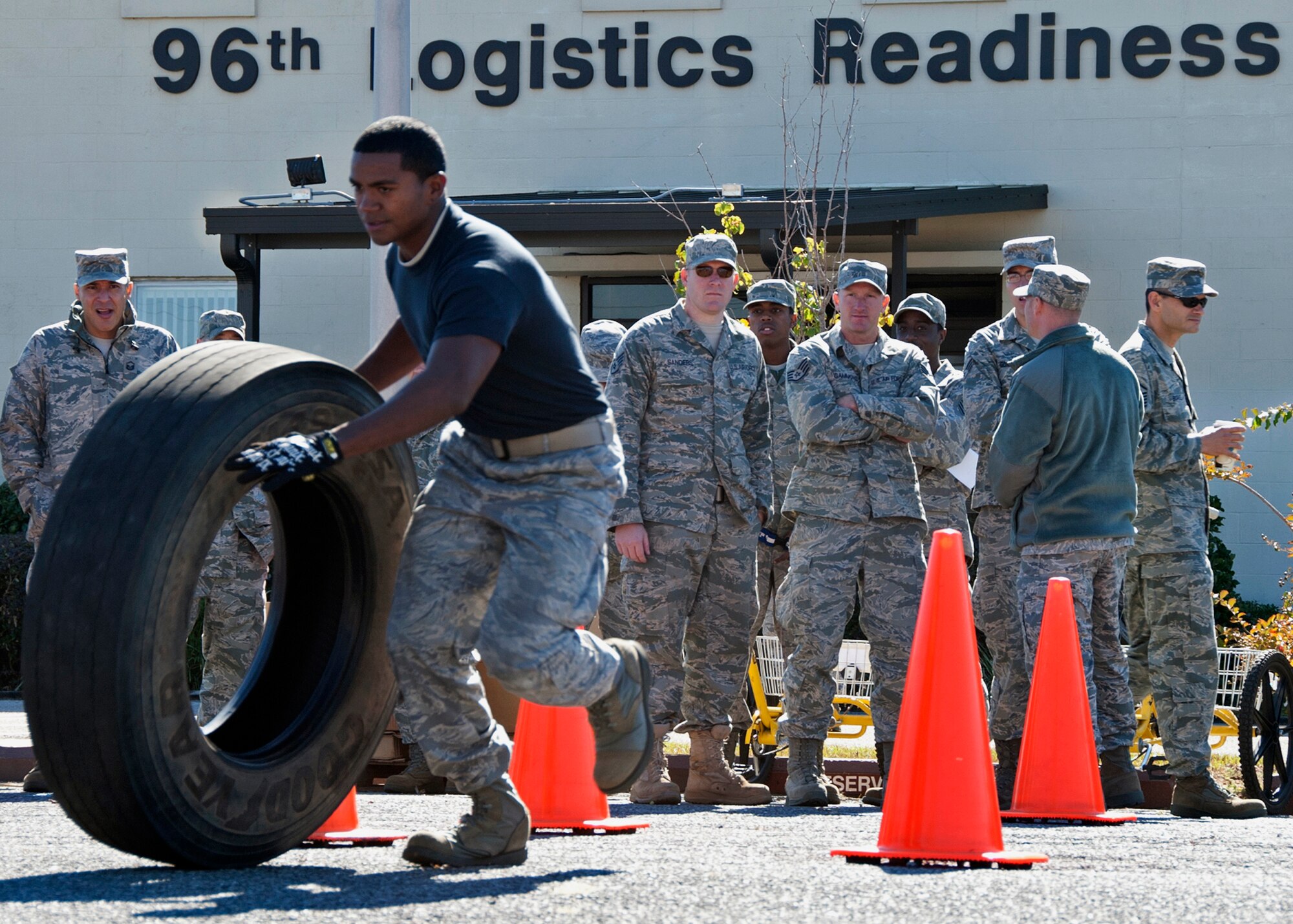 A member of the 1st Special Operations Logistics Readiness Squadron rolls a tire around cones as part of the tire change portion at the first-ever Eglin/Hurlburt Field LRS competition Nov. 5.  Hurlburt’s “Team A” won the overall competition almost five minutes.  The “best-time” competition included pallet building, obstacle courses and tire changing.  (U.S. Air Force photo/ Samuel King Jr.)