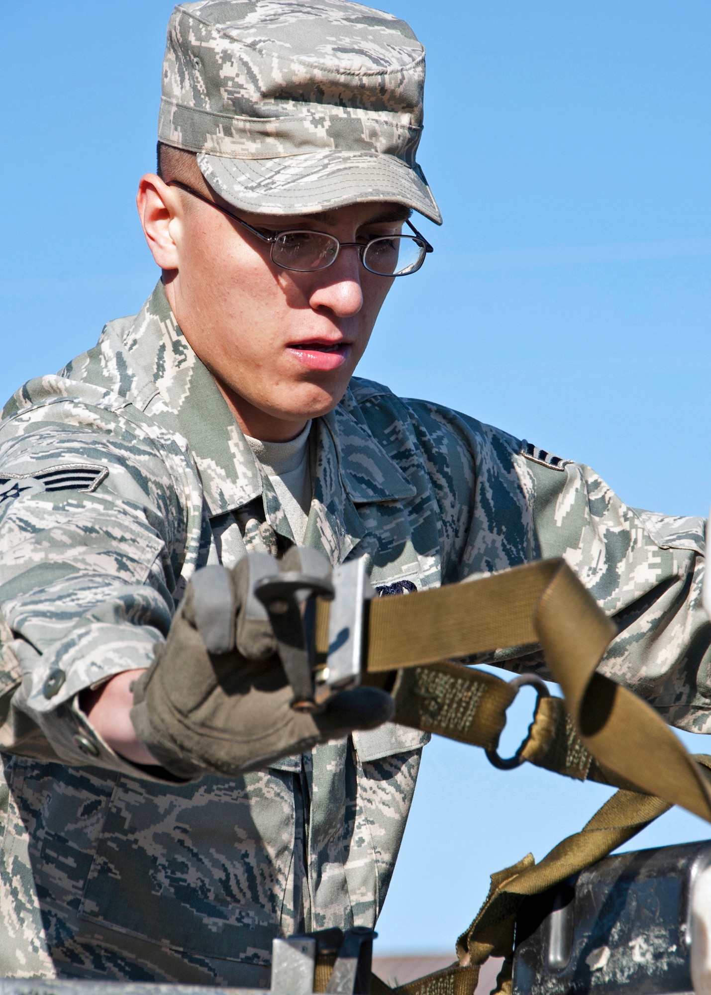 Senior Airman Tyler Donoho, 96th Logistics Readiness Squadron, secures the boxes with straps during the pallet loading portion at the first-ever Eglin/Hurlburt Field LRS competition Nov. 5.  Hurlburt’s “Team A” won the overall competition almost five minutes.  The “best-time” competition included pallet building, obstacle courses and tire changing.  (U.S. Air Force photo/ Samuel King Jr.)
