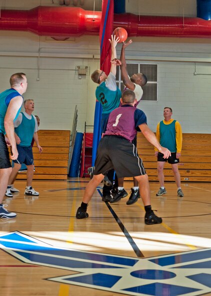 The Commanders and Shirts grapple for control of the ball to begin the game Nov. 8 at Eglin Air Force Base, Fla.  The game began Eglin’s first-ever commanders versus shirts sports competition.  Dave Meissen and Tim Welde “commanded” the game to an easy 44-25 victory. (U.S. Air Force photo/ Samuel King Jr.)