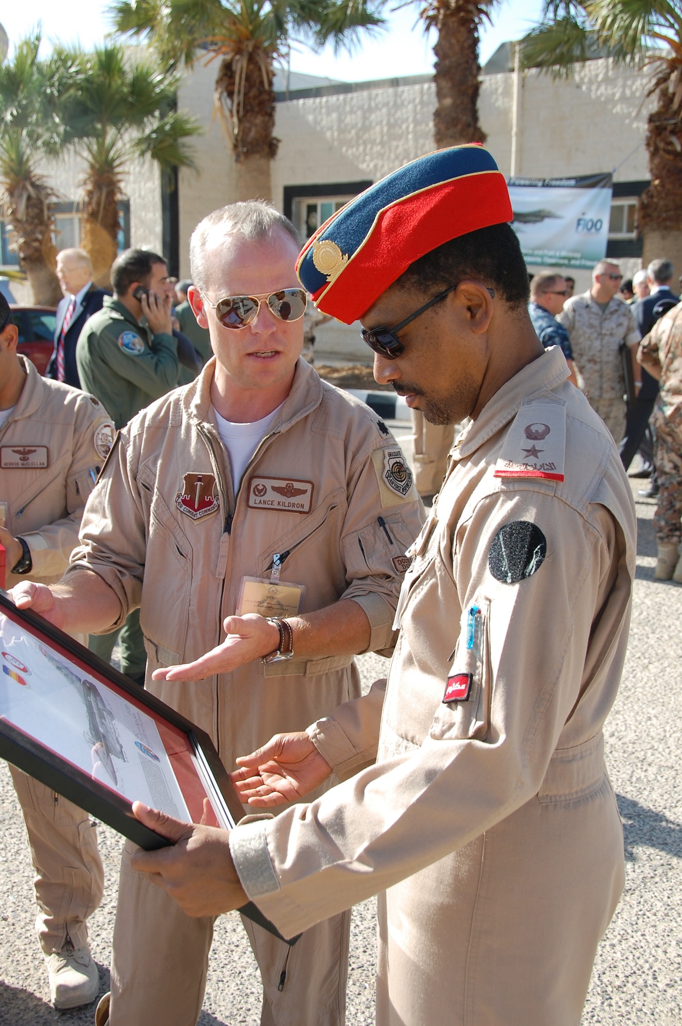Maj. Adel H. Bin Sanqour, of the United Arab Emirates air force, receives an appreciation plaque from Lt. Col. Lance Kildron Nov. 2, 2010, after the closing ceremonies at Falcon Air Meet 2010 in Azraq, Jordan. Colonel Kildron is the 77th Fighter Squadron commander. (U.S. Air Force photo/Alan Black)