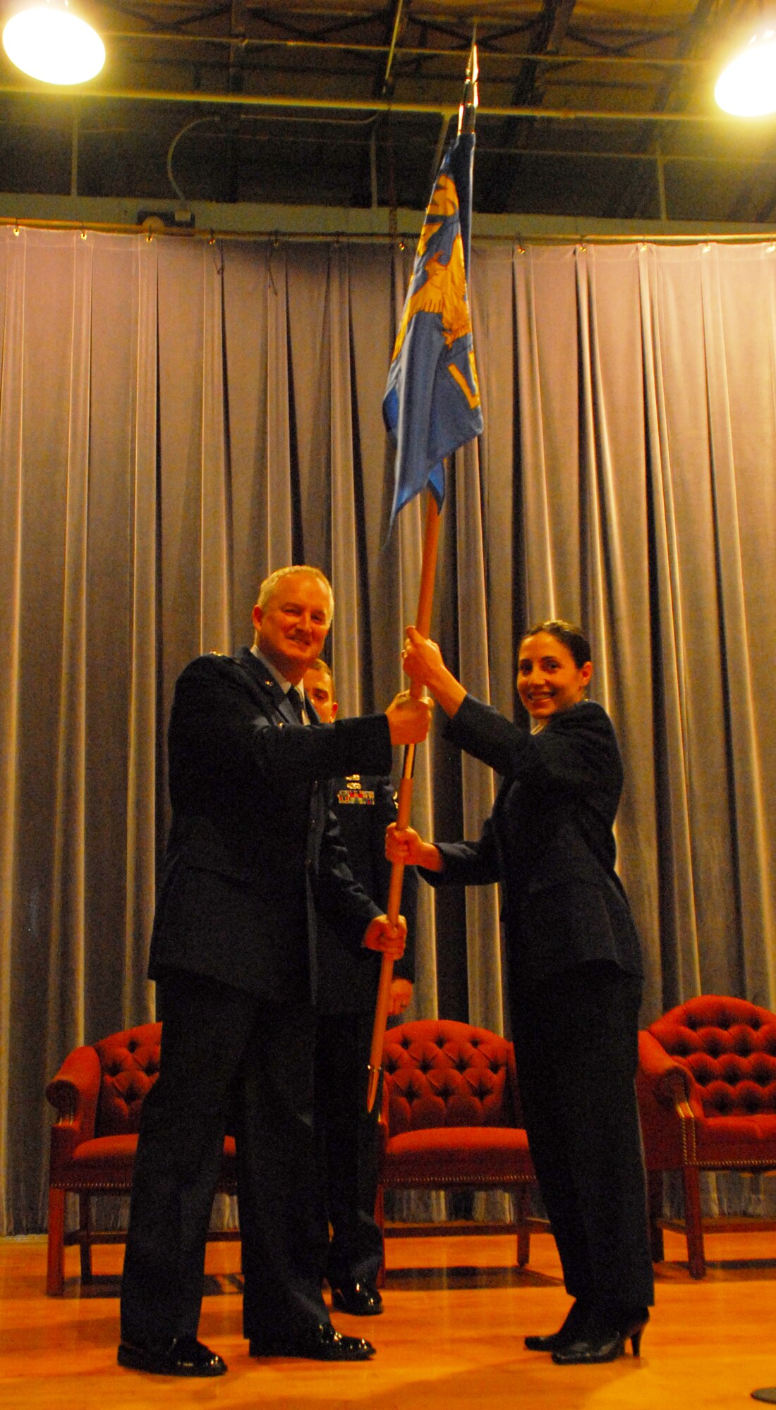 Col. Timothy McCoy, 914th Mission Support Group commander, presents Capt. Gina Pizziconi-Cupples, the new 914th Logistics Readiness Squadron commander, with the 914 LRS flag as part of a change of command ceremony Nov. 7 at the Niagara Falls Air Reserve Station