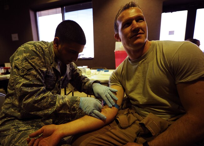 Capt. Austin Street waits while his blood is drawn Nov. 7, 2010 on Joint Base Charleston, S.C. Medical technicians draw blood from Airmen returning from some deployed areas to screen for viruses or diseases. Captain Street is the deputy chief of training for the 15th Airlift Squadron. (U.S. Air Force photo/Senior Airman Timothy Taylor)