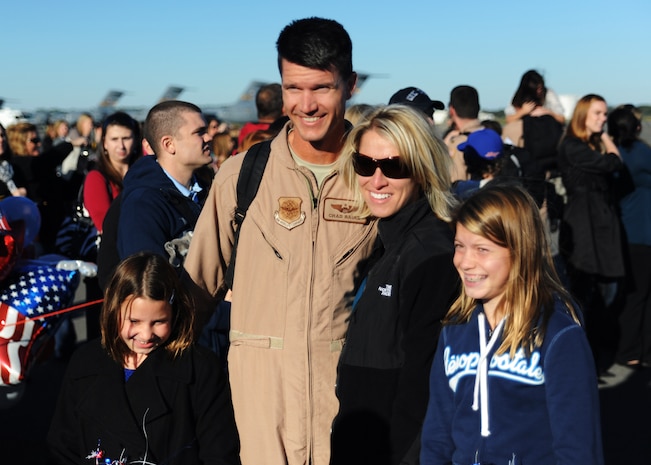 Lt. Col. Chad Rauls takes a family photo with his wife Jodi and his daughters Allison (left) and Gabi (right) after returning home from a deployment to the Middle East Nov. 7, 2010 on Joint Base Charleston, S.C. Colonel Rauls is the director of operations for the 15th Airlift Squadron. (U.S. Air Force photo/Senior Airman Timothy Taylor)