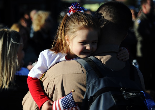 Staff Sgt. Michael Barker and his daughter Julia hug after being reunited from his deployment to the Middle East Nov. 7, 2010 on Joint Base Charleston, S.C.  More than 120 Airmen from the 15th Airlift Squadron returned home after a four-month deployment to the Middle East. While deployed, the Airmen flew roughly 3,500 sorties and airlifted more than 125 million pounds of cargo throughout the area of responsibility. Sergeant Barker is an instructor loadmaster with the 15th Airlift Squadron. (U.S. Air Force photo/Senior Airman Timothy Taylor)