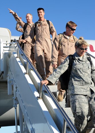 Airmen from the 15th Airlift Squadron point and wave to friends and loved ones after arriving from a twenty hour flight home Nov. 7, 2010 on Joint Base Charleston, S.C. More than 120 Airmen from the 15th Airlift Squadron returned home after a four-month deployment to the Middle East. While deployed, the Airmen flew roughly 3,500 sorties and airlifted more than 125 million pounds of cargo throughout the area of responsibility. (U.S. Air Force photo/Senior Airman Timothy Taylor)