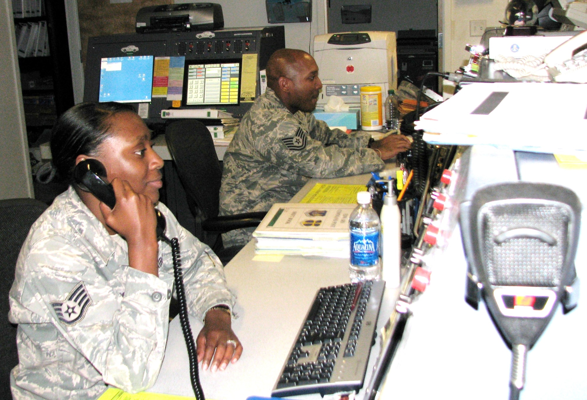 Staff Sgt. Tiffany Marroquin (foreground) and Tech. Sgt. Philip Lucas man 95th Air Base Wing Command Post day shift.  The Command Post has a team of volunteer drivers from different communities whom they can call anytime night or day and have them pick up an impaired person(s) and drive him, her or them home. (Air Force photo by Diane Betzler)