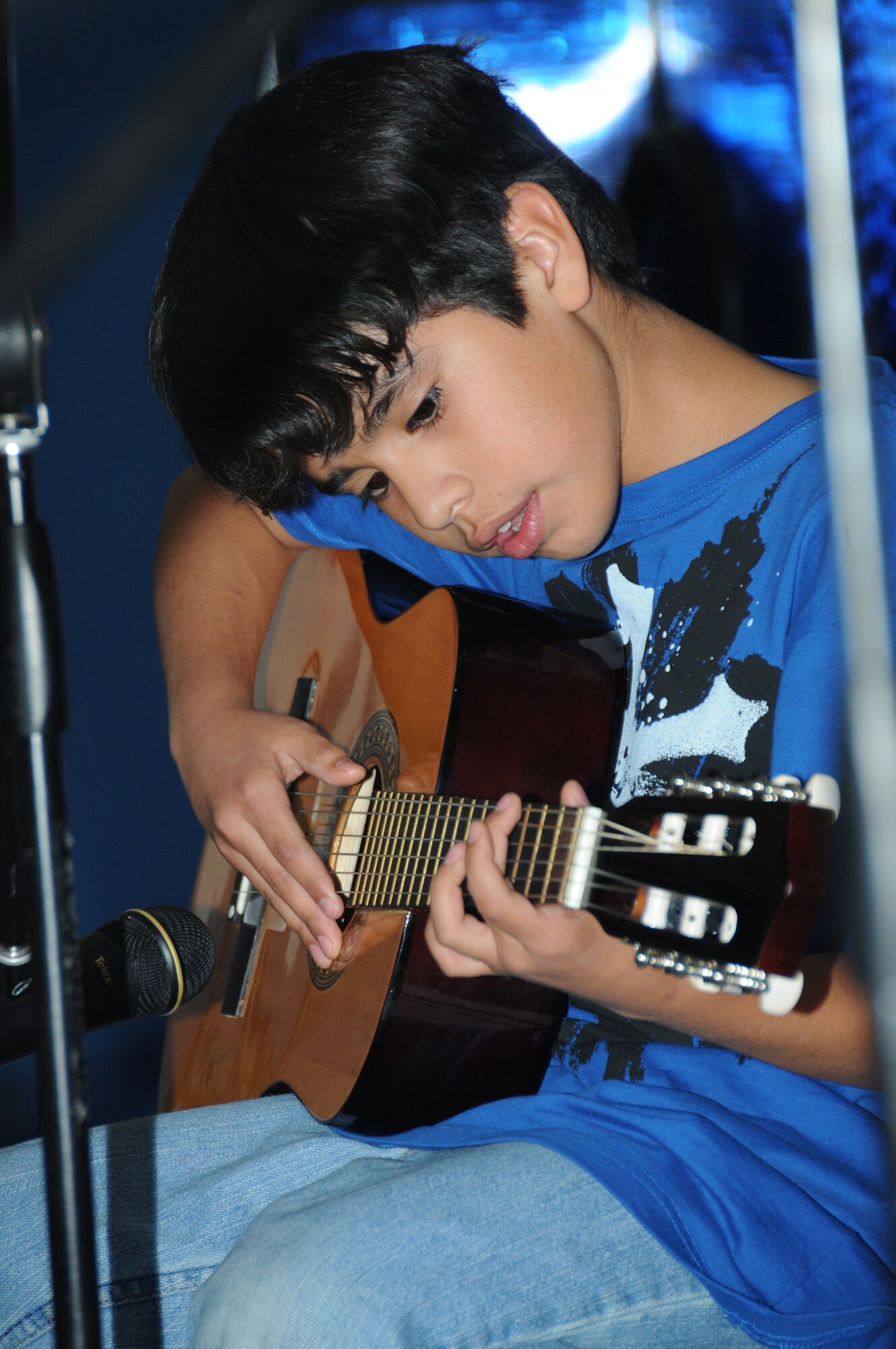 Junie Robles, 9, son of Tech. Sgt. Maria and Lupe Robles, 81st Medical Operations
Squadron, plays “The First Rock” and “Riffs and Melodies on One String.”  (U.S. Air Force photo by Kemberly Groue)