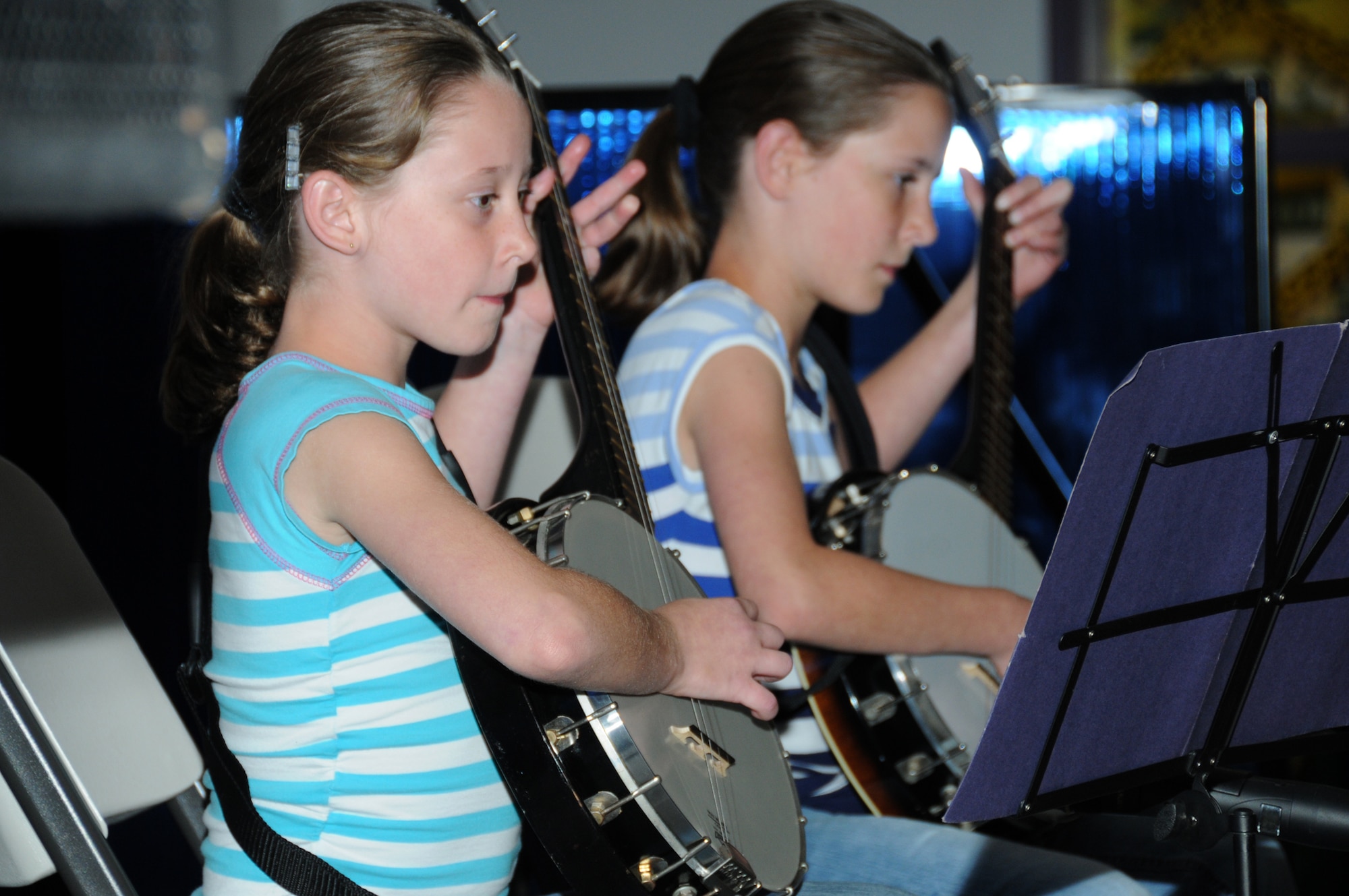 From left, Mallory LeBlanc, 10, and her sister Megan, 11, play “Yes Sir, That’s My Baby” on their banjos at the youth center talent show Friday. Their parents are Master Sgt. Robert and Misty LeBlanc, 333rd Training Squadron.  (U.S. Air Force photo by Kemberly Groue)