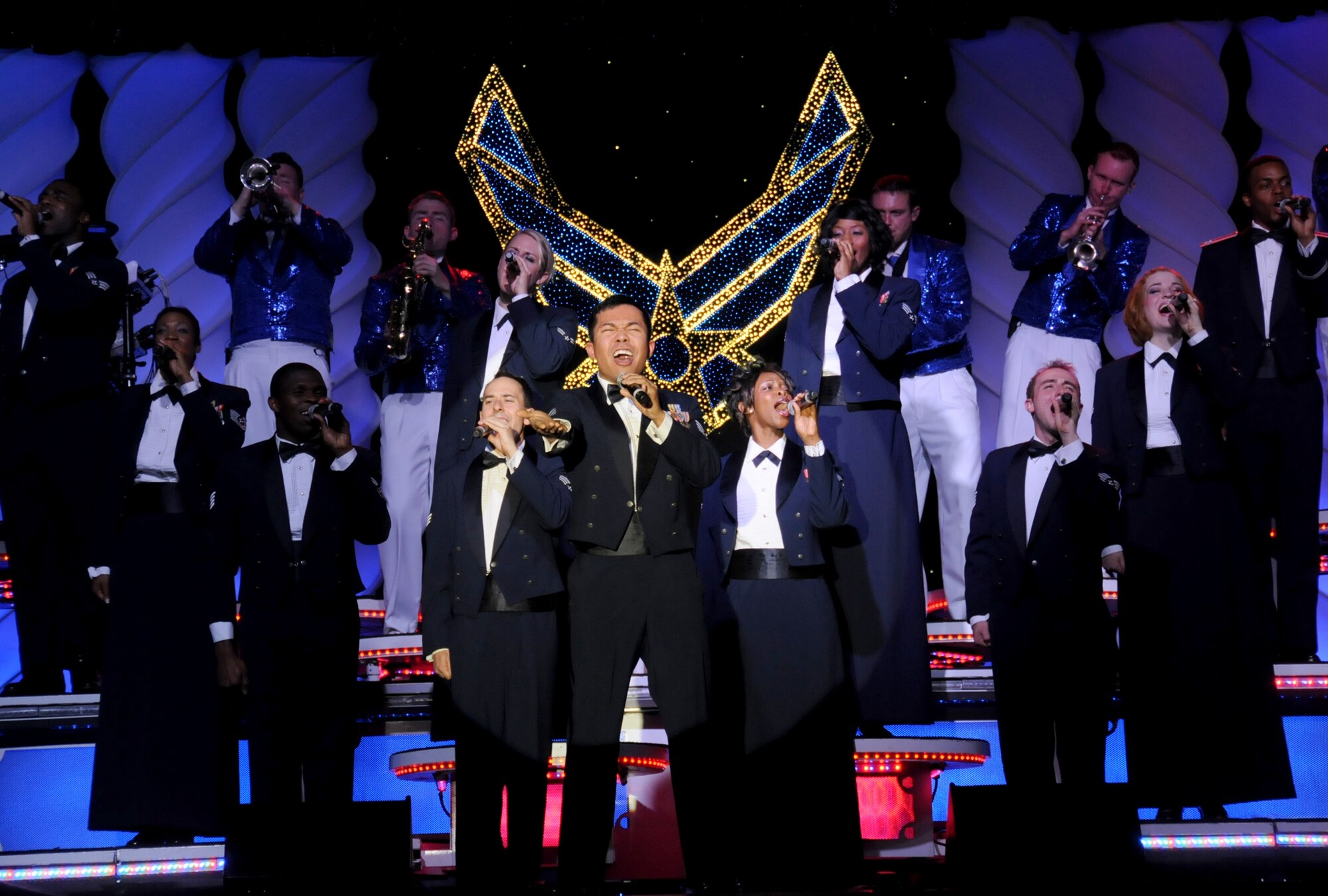 Staff Sgt. Harron Elloso sings Lee Greenwood’s “God Bless the USA” at Tops in Blue’s Nov. 4 performance at the Mississippi Coast Coliseum in Biloxi. Sergeant Elloso is from Langley Air Force Base, Va. Tops in Blue is an active-duty special unit made up of talented amateurs that performs across the U.S. and around the world as Air Force musical ambassadors.  (U.S. Air Force photo by Kemberly Groue)
