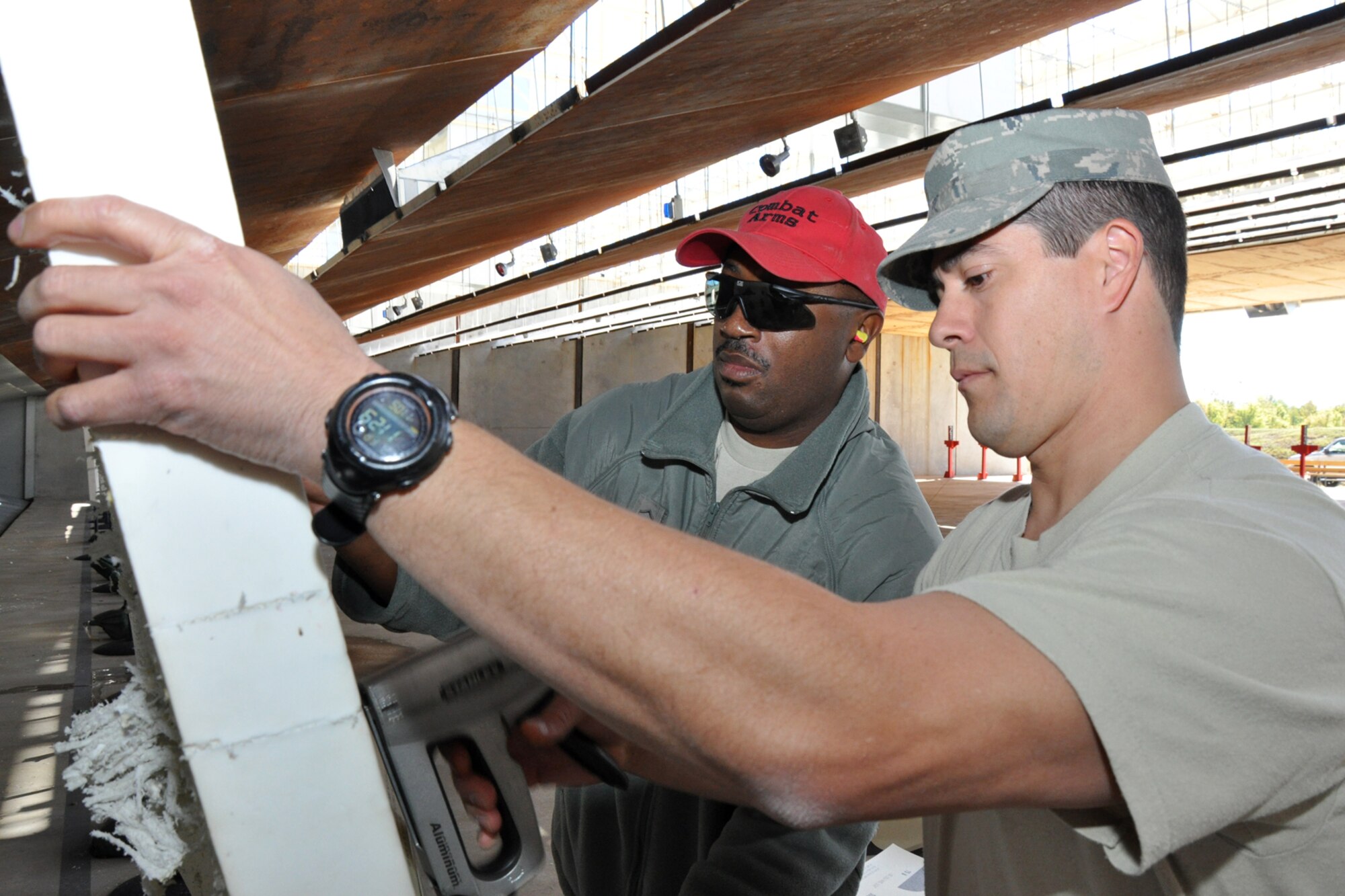 Master Sgt. B.K. Nelson, non-commissioned officer-in-charge, 917th Security Forces Squadron Combat Arms, and Staff Sgt. Josh Feliciano, 917th SFS, Combat Arms, prepare targets for Airmen from the 917th Civil Engineer Squadron who are trying to qualify with the M4, 5.56mm, Carbine on the firing range at Barksdale Air Force Base, La., Nov 5, 2010. The 917 CES Airmen are completing the annual weapons training to keep current in their war fighting skills. The training is necessary to keep the unit ready to deploy with little or no notice in defense of the United States and its interests. (U.S. Air Force photo/Tech. Sgt. Jeff Walston)   
 
