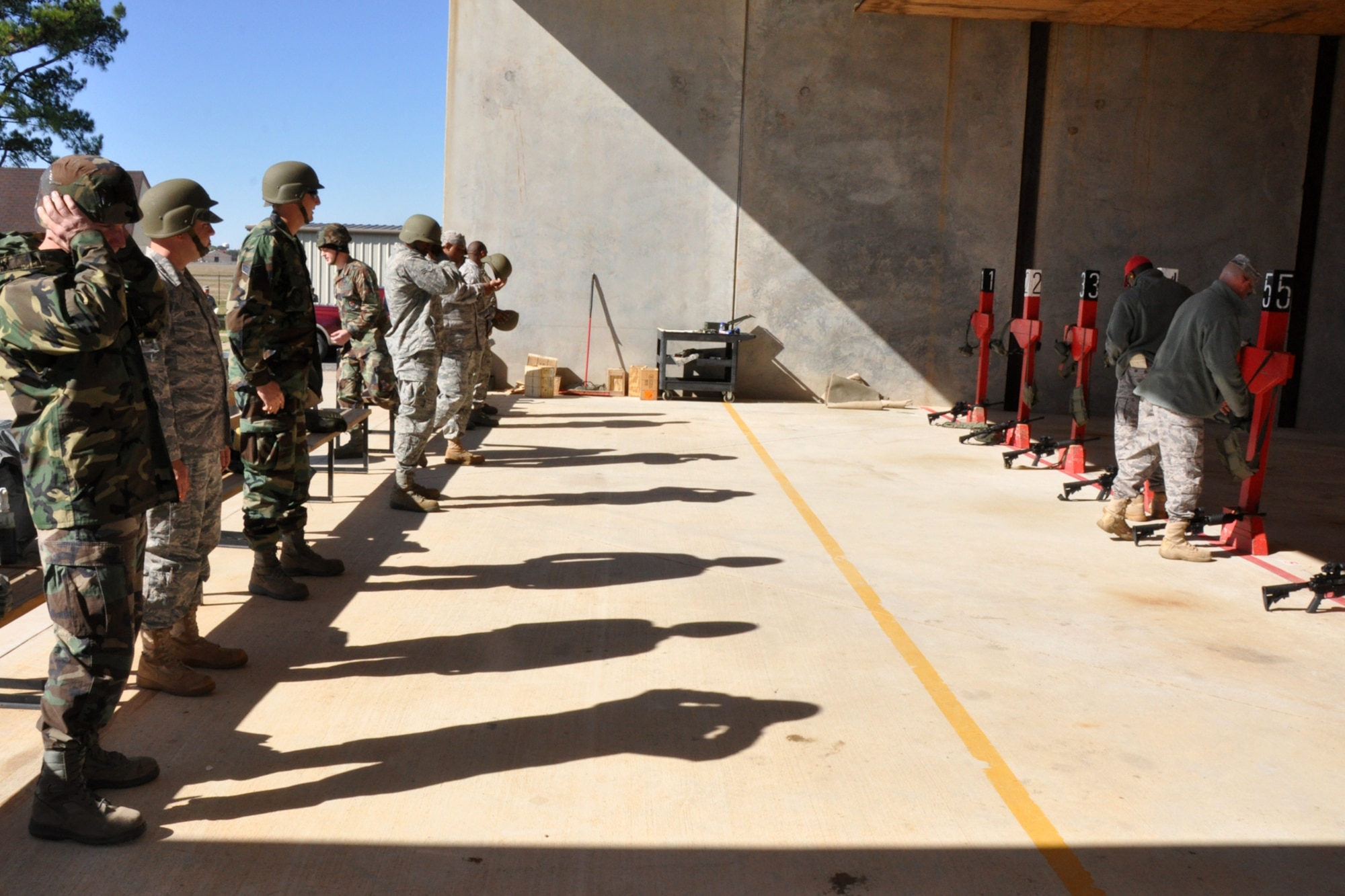 Airmen from the 917th Civil Engineer Squadron prepare themselves to fire the M4, 5.56mm, Carbine at the firing range on Barksdale Air Force Base, La., Nov 5, 2010. This particular version of the M4 has a telescoping stock, which allows more effective use of the weapon in building structures during close-quarter combat operations. The 917 CES Airmen are completing the annual weapons training to keep current in their war fighting skills. The training is necessary to keep the unit ready to deploy with little or no notice in defense of the United States and its interests. (U.S. Air Force photo/Tech. Sgt. Jeff Walston)   