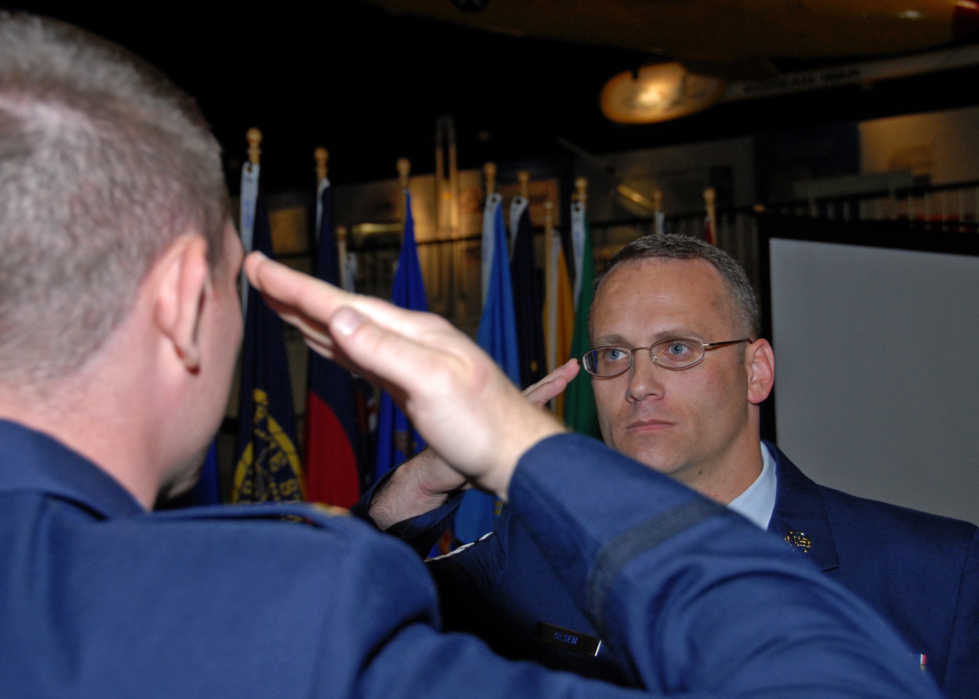 Master Sgt. Mark Olsen gives his final salute to his son 2nd Lt. Nicholas Brewer  at his retirement ceremony, Nov. 5. The F-15 Eagle Avionics technician retired after 22 years of service with his son officiating the ceremony. (U.S. Air Force photo/Sachel Seabrook)


