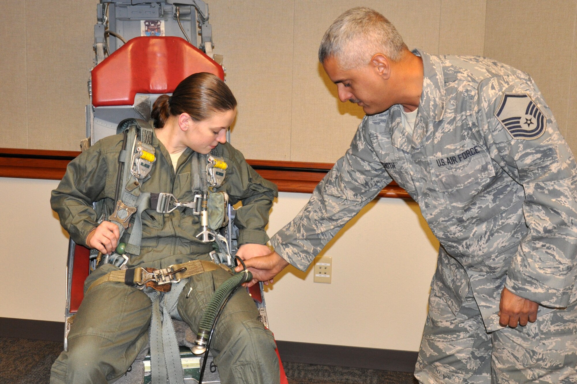 Master Sgt. Bradley Schoth, 917th Operations Support Flight, non-commissioned officer in charge of aircrew flight equipment instructs Senior Airman Kimberly Simon, 717th Aircraft Maintenance Squadron, in emergency egress and parachute training at the 93rd Bomb Squadron Headquarter building on Barksdale Air Force Base, La., Nov. 5, 2010. Airman Simon received an “incentive ride” in a B-52 Stratofortress for being chosen as the 917th Wing Airman of the Quarter for the second quarter of 2010. This was her first flight in a B-52. (U.S. Air Force photo/Tech. Sgt. Jeff Walston)