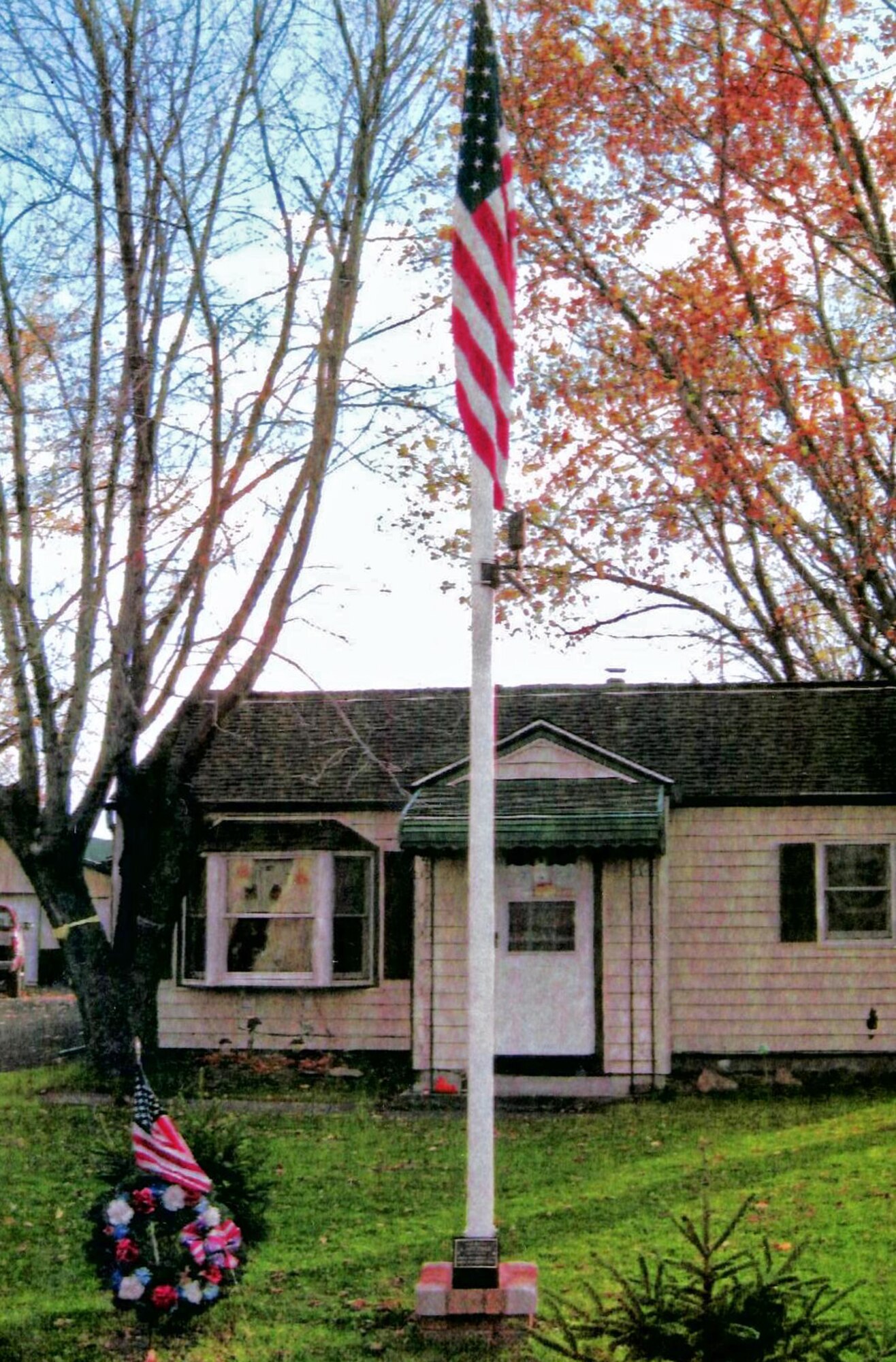 The flagpole flag and plaque volunteers donated and installed, November 9, 2010, Wheatfield NY. Friends from the 914th and 107th Airlift Wing’s along with Cub Scout Pack 833 out of Adams Fire Hall in Wheatfield, helped in establishing a memorial flag pole and plaque in honor of Army Spc. Alan Dikcis. (Courtesy photo)