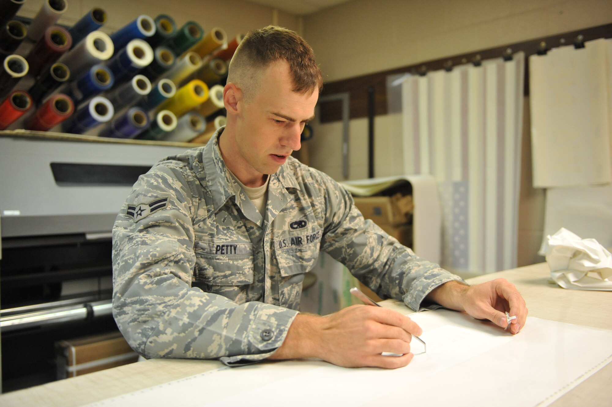 Airman 1st Class Jacob Petty, 19th Equipment Maintenance Squadron corrosion control apprentice, peels off stencils Oct. 31. Airman Petty was selected to receive the Chiefs Sharp Troop award for his job performance and education efforts. He revived five C-130 engines and halted corrosion by applying a protective coating and led 12 C-130 wheel preps, boosting supply levels above critical status. Airman Petty also earned six credit hours in aviation maintenance technology toward his Community College of the Air Force degree, boasting a 4.0 grade point average.